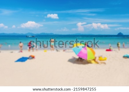 Blurred crowd of people and beautiful white sand beach background, Summer vacation concept and copy space