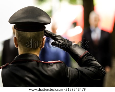 Shallow depth of field (selective focus) details with an Italian policeman in a ceremonial uniform saluting. Royalty-Free Stock Photo #2159848479