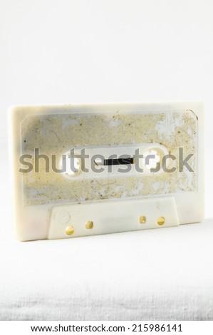 Ancient Vintage Used Musicassette over a White Background