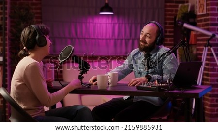 Man having casual conversation with woman in internet broadcast using professional microphone and audio mixer. Online radio station host recording podcast interviewing guest in late night talk show.