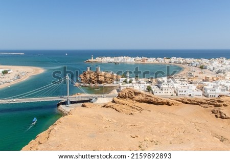 Sur, Oman - an important point for sailors and famous also for its building wooden ships, Sur is a pearl of Oman, with its fusion of green waters, white buildings and red rocks Royalty-Free Stock Photo #2159892893
