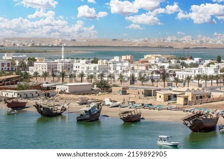 Sur, Oman - an important point for sailors and famous also for its building wooden ships, Sur is a pearl of Oman, with its fusion of green waters, white buildings and red rocks Royalty-Free Stock Photo #2159892905