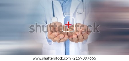 Doctor holding a vaccine and  icon in his hand