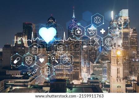 Aerial panoramic cityscape of Philadelphia financial downtown at night time, Pennsylvania, USA. Hologram healthcare digital medicine icons. The concept of treatment from disease, Threat of pandemic