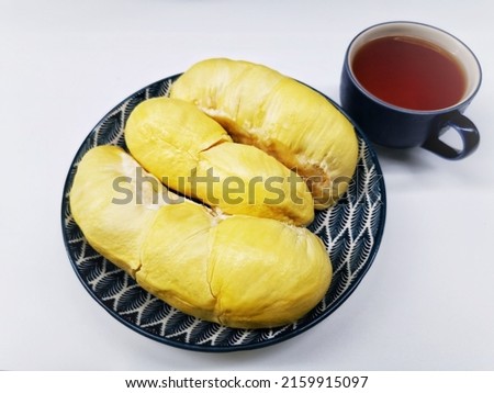 Many durians in dish and tea cup on the white table