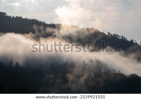 sunrise with fog in the mountains after a rainy night