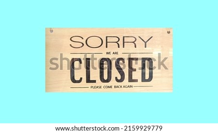 Sorry we're closed sign. on light blue background