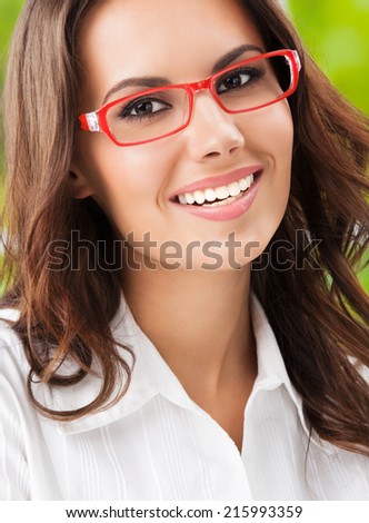 Portrait of young happy smiling businesswoman at office