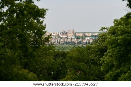 View from above to Pitesti city from Arges County, next to Bucharest, Romania, through a forest. Royalty-Free Stock Photo #2159945529