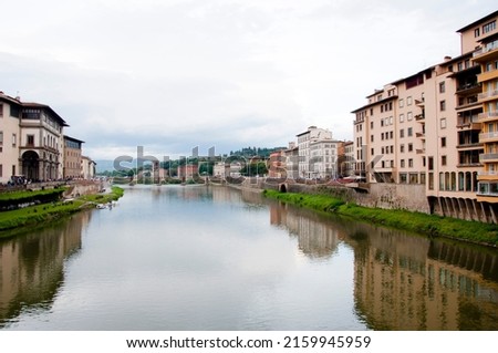 Florence waterfront with Ponte alla Grazie bridge over Arno river in Italy.