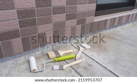 Outer walls and painting tools. Royalty-Free Stock Photo #2159953707