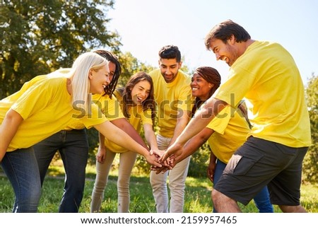 Successful young start-up team stacking hands for motivation and community Royalty-Free Stock Photo #2159957465