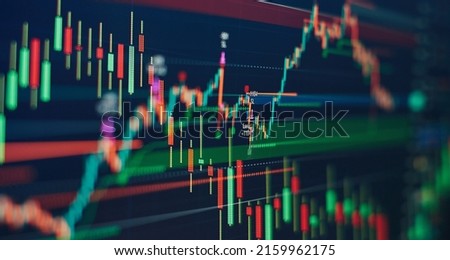 Technical price graph and indicator, red and green candlestick chart on blue theme screen, market volatility, up and down trend. Stock trading, crypto currency background. Royalty-Free Stock Photo #2159962175