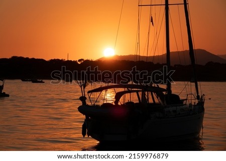 A jet ski on the sea with an orange sunset in the background. Picture taken in the mediterranean sea in southern France