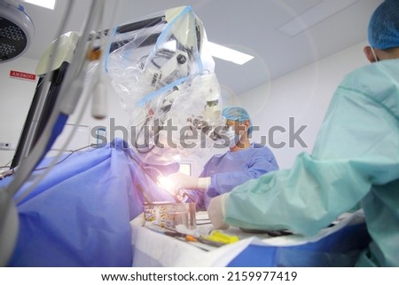 Treatment of a brain aneurysm. Surgical operation on the brain. A team of surgeons performing brain surgery to remove a tumor. Royalty-Free Stock Photo #2159977419