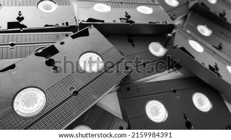 Messy stack of VHS tapes. Video Home System tape cassettes. Royalty-Free Stock Photo #2159984391