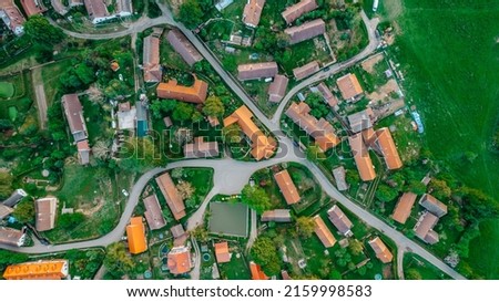 Aerial view of a small village.Top view of traditional housing estate in Czech. Looking straight down with a satellite image style.Houses from above, real estate concept.Country road urban scene Royalty-Free Stock Photo #2159998583