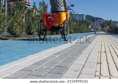 a man rides down the street on a three-wheeled bicycle along a cycle
