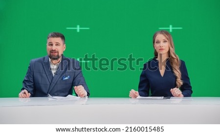 Newsroom TV Studio Live News Program: Caucasian Male and Female Presenters Reporting, Green Screen Chroma Key Screen Picture. Television Cable Channel Anchor Talks, Listens. Network Broadcast Mock-up