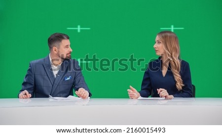 Newsroom TV Studio Live News Program: Caucasian Male and Female Presenters Reporting, Green Screen Chroma Key Screen Picture. Television Cable Channel Anchor Talks, Listens. Network Broadcast Mock-up
