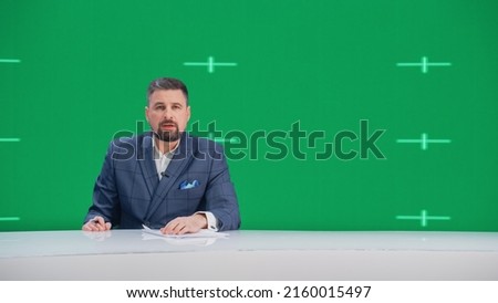 Newsroom TV Studio Live News Program: Caucasian Male Presenter Reporting, Green Screen Chroma Key Screen Picture. Television Cable Channel Anchor Talks, Listens. Network Broadcast Mock-up
