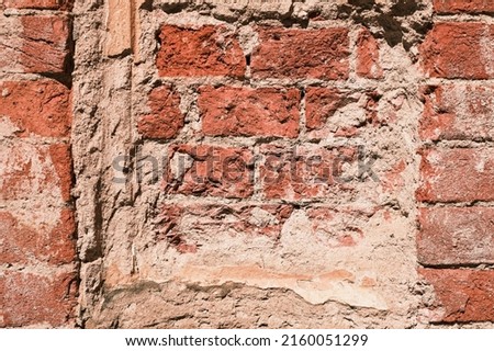 Background of the ruins of an old house, a wall of red bricks in salt smudges, the texture of natural bricks. Grunge background