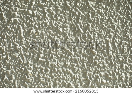 Texture of plaster on wall. Stone wall is white. Small stone. Rough surface.
