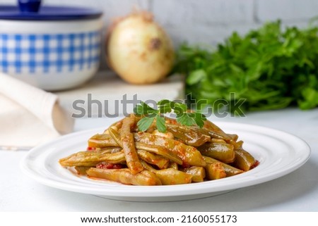 Traditional delicious Turkish food; Green beans with olive oil; Turkish name; Zeytinyagli taze fasulye Royalty-Free Stock Photo #2160055173