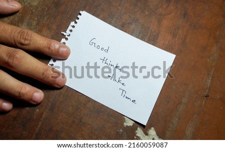 Hand written motivational word Good thinks take time. Men hand holding lifestyle motivational positive words written on a wooden background. Business, signs, symbols, concepts. Copy space.