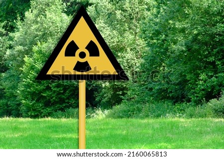 yellow sign warning the nuclear risk in Chernobyl area in Ukraine, message about the danger of exposure to a high dose of absorbed radiation after an accident at a nuclear power plant