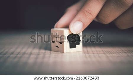 Ethics inside human mind, Business ethics concept. Hand flip ethics inside a head symbols in wooden cubes on dark background with copy space. Royalty-Free Stock Photo #2160072433