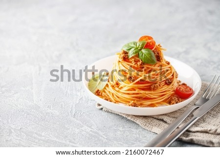 Pasta Spaghetti Bolognese in white plate on gray background. Bolognese sauce is classic italian cuisine dish. Popular italian food. Royalty-Free Stock Photo #2160072467