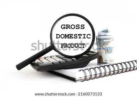 GDP . or Gross Domestic Product, white background with a magnifying glass on a black calculator. text on magnifying glass