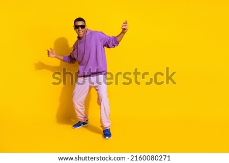 Full length body size view of attractive trendy guy dancing chill out copy space isolated over vivid yellow color background Royalty-Free Stock Photo #2160080271
