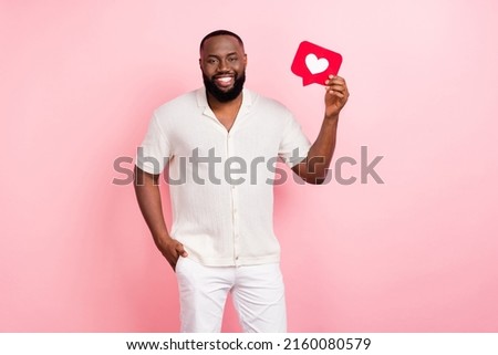 Photo of pretty adorable guy dressed white shirt smiling rising heart like sign isolated pink color background