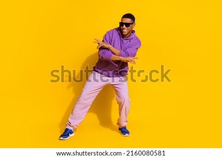 Full length body size view of attractive cheerful guy dancing moving rest street isolated over bright yellow color background Royalty-Free Stock Photo #2160080581
