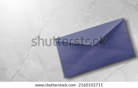 Navy violet envelope on desk. Kraft paper with subtle fibers.