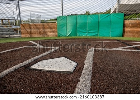 Angled view of a large, empty baseball field on a bright, sunny day
