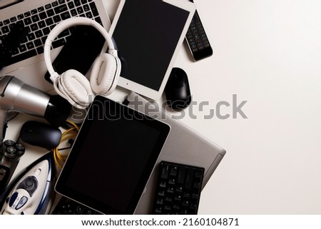 Old computers, digital tablets, mobile phones, many used electronic gadgets devices, broken household and appliances on white background. Planned obsolescence, electronic waste for recycling concept Royalty-Free Stock Photo #2160104871