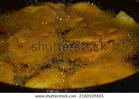 Fritters (Pakora) are fried in hot oil.