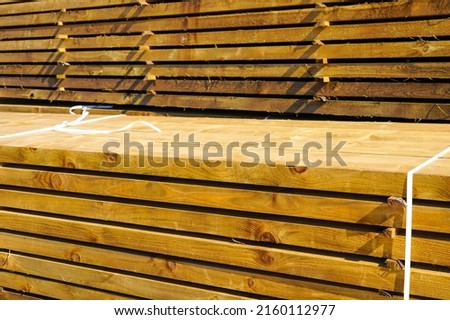 Stacked impregnated thick high quality pine wood boards for background and texture Royalty-Free Stock Photo #2160112977
