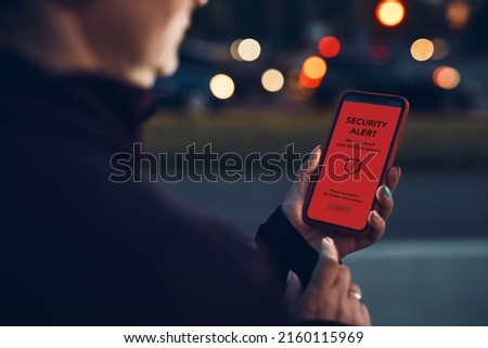 Security alert on smartphone screen. Antivirus warning. Private data protection system notification. Important security issue. Concept of cyber crime, hacking password and bank accounts stealing money Royalty-Free Stock Photo #2160115969