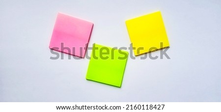 Isolated paper notes on the gray white background.
