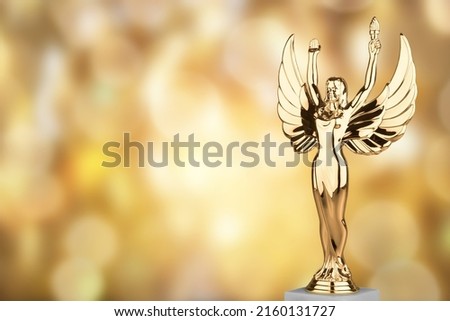 Hollywood Golden Academy award statue on fireworks background. Success and victory concept.