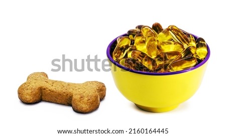 Vegan dog biscuit enriched with omega 3, isolated white background, fish oil-based vitamin, healthy homemade food for puppies Royalty-Free Stock Photo #2160164445