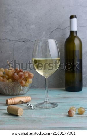 Glass of white wine and grapes on a table
