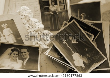 old family photos, pictures from 1935 in sepia color on wooden table, home archive documents, concept of family tree, genealogy, memories, memory of ancestors, family tree, nostalgia Royalty-Free Stock Photo #2160177863