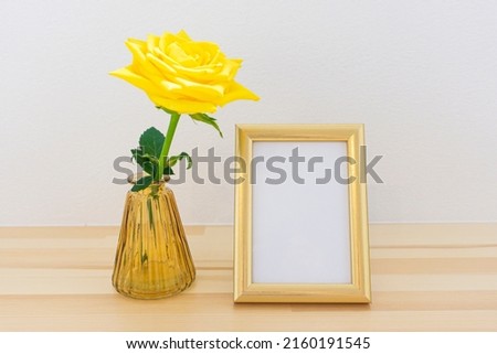 Photo frames and flowers on the table
