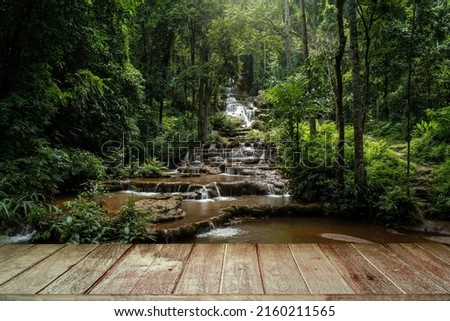 Textured Tabletop Against Waterfall And Forest.