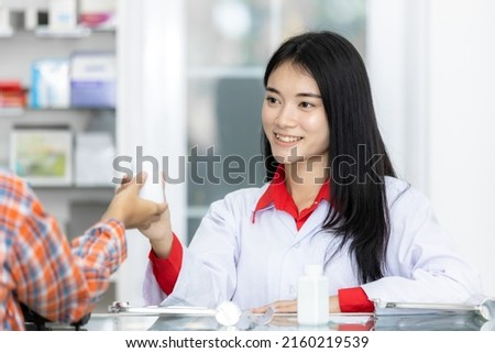 Asian medicine doctor giving a blister of pill to patient, Hand doctor pharmacist giving medical prescription to female patient, Asian doctor holding the medicine and presenting the elderly patient.